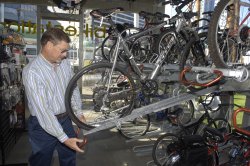 A man loads a bike onto a rack in the station.