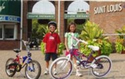 Two children pose with their bikes.