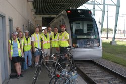 Bicyclists in front of a METRO train.